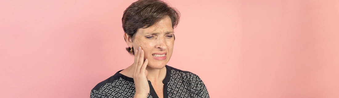 Dentist Eden UT Woman With Tooth Pain On Pink Background